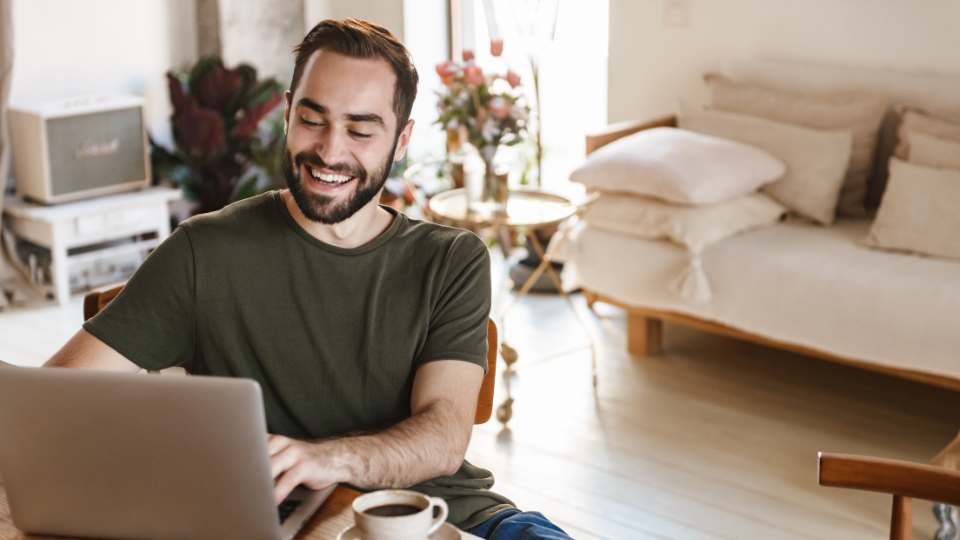 Happy man working from home: work from home has many advantages such as better employee productivity and increased organizational commitment